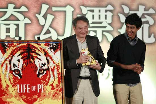 Taiwanese director Ang Lee, left, and lead actor from India Suraj Sharma accept gifts a during press conference announcing their new film Life of Pi, in Taipei, Taiwan, Wednesday, Nov. 7, 2012. 