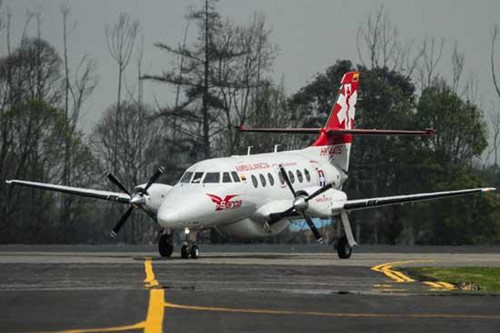 An air ambulance transporting four Chinese workers of an oil company is seen upon landing at the airport in Bogota, Colombia, on Nov. 22, 2012. (Xinhua/Jhon Paz)