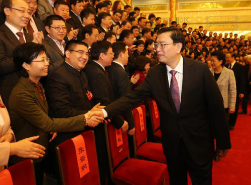 Zhang Dejiang, Chinese Vice Premier and a member of the Standing Committee of Political Bureau of the Communist Party of China Central Committee, shakes hands with delegates attending the 14th National Congress of China Zhi Gong Party in Beijing, China, Dec. 3, 2012. (Xinhua/Liu Weibing)