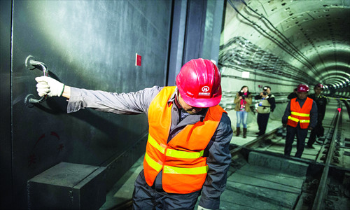 A worker checks a gate at Chengshousi Subway Station on the second phase of Subway Line 10 Tuesday. The gate can seal off subway stations and tunnels in case of a poison gas or nuclear attack. Photo: Li Hao/GT 
