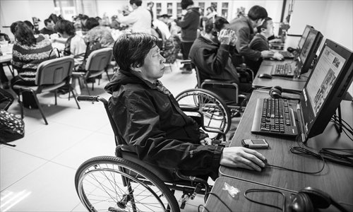 People surf the Internet at Wenxin Jiayuan community center for the disabled in Chaoyang district Tuesday. Photo: Li Hao/GT 