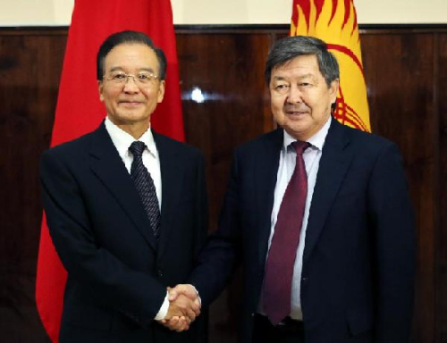 Chinese Premier Wen Jiabao (L) holds talks with Kyrgyz Prime Minister Zhantoro Satybaldiyev in Bishkek, capital of Kyrgyzstan, Dec. 4, 2012. Wen Jiabao arrived here Tuesday to attend the 11th prime ministers' meeting of the Shanghai Cooperation Organization (SCO) and pay an official visit to Kyrgyzstan. (Xinhua/Yao Dawei)
