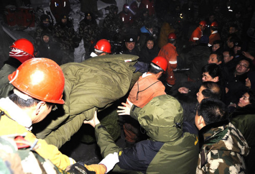 A rescued miner is moved to an ambulance after being trapped in a flooded coal mine for five days in Qitaihe city, Northeast China's Heilongjiang province, on Dec 7, 2012. A total of 22 miners were working underground when the accident occurred on Saturday. Six miners escaped, and two were escorted out of the mine at noon Sunday. Three miners have been confirmed dead. Rescuers are still searching for seven others who are missing.[Photo/Xinhua] 