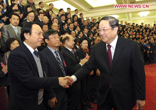 Yu Zhengsheng (R front), a member of the Standing Committee of the Political Bureau of the Communist Party of China (CPC) Central Committee, meets with delegates to the 15th National Congress of the Chinese Peasants and Workers Democratic Party (CPWDP) in Beijing, capital of China, Dec. 6, 2012. The CPWDP, a non-Communist political party, opened its 15th National Congress on Thursday in Beijing. Yu Zhengsheng met with CPWDP delegates and gave a congratulatory speech on behalf of the CPC Central Committee. (Xinhua/Rao Aimin)
