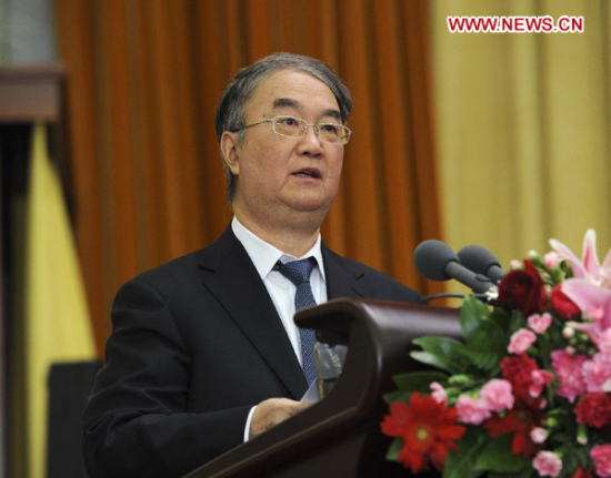 Sang Guowei, standing chairman of the presidium of the 15th National Congress of the Chinese Peasants and Workers Democratic Party (CPWDP), delivers a work report at the opening ceremony of the CPWDP national congress on behalf of the party's 14th Central Committee in Beijing, capital of China, Dec. 6, 2012. The CPWDP, a non-Communist political party, opened its 15th National Congress on Thursday in Beijing. (Xinhua/Rao Aimin)