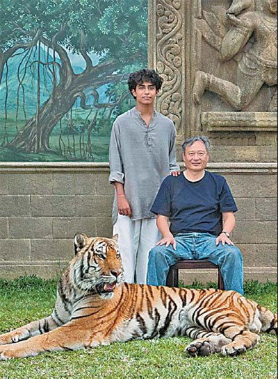 Director Ang Lee with two lead characters in Life of Pi - Indian actor Suraj Sharma and a Bengal tiger. Provided to China Daily