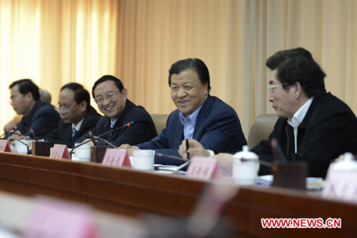 Liu Yunshan (2nd R), a member of the Standing Committee of the Political Bureau of the Communist Party of China (CPC) Central Committee, speaks during a symposium attended by officials and citizen members of Beijing's enterprises, villages and universities, in Beijing, capital of China, Dec. 10, 2012. At the symposium, Liu called for tenets of the 18th Party Congress to be implemented thoroughly in work, study and words. (Xinhua/Xie Huanchi)