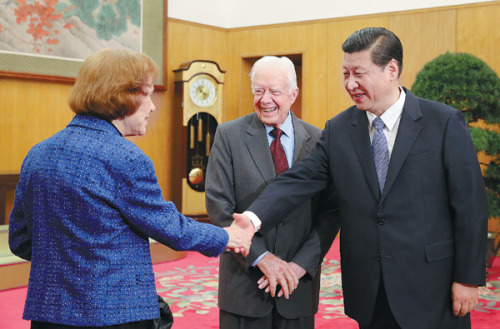 Former US president Jimmy Carter introduces his wife, Rosalynn, to Xi Jinping, China's top political leader and head of the military, in Beijing on Thursday. [Photo by XU JINGXING / CHINA DAILY]