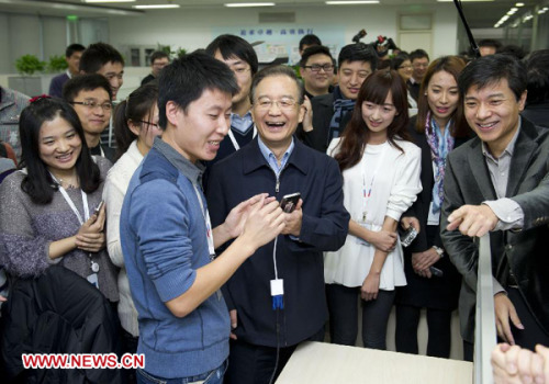 Chinese Premier Wen Jiabao tries a voice search application for mobile phone when visiting Baidu, a search engine giant, during an inspection tour to Zhongguancun, a Beijing-based technology hub, in Beijing, capital of China, Dec. 13, 2012. (Xinhua/Huang Jingwen)