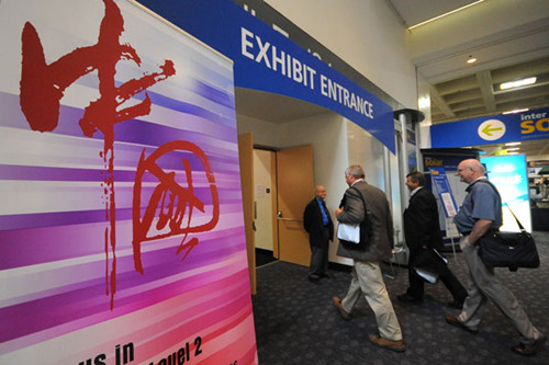 Visitors enter an exhibit for Chinese solar energy companies at Intersolar North America 2011 in San Francisco, California, in July 2011. [Liu Yilin / Xinhua]