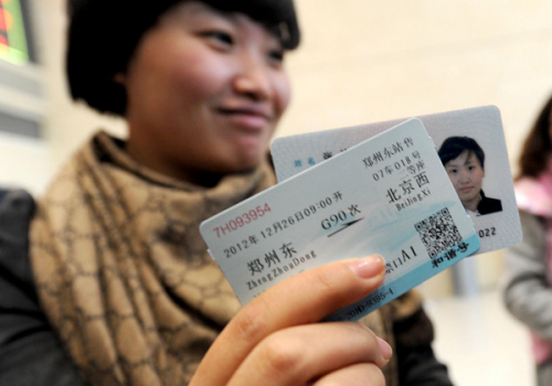 A passenger manages to buy the first high-speed train ticket from Zhengzhou, capital of Central China's Henan province, to Beijing at Zhengzhou East Railway Station on Dec 20, 2012. Tickets for high-speed trains from Beijing to the southern Chinese city of Guangzhou went on sale on Thursday. [Photo/Xinhua] 