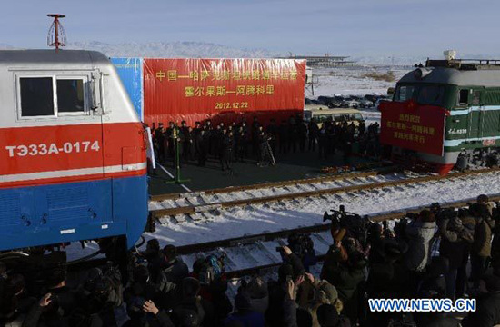 Trains linking Korgas Pass of China and Sary-Ozek railway of Kazakhstan start to move during the ceremony to celebrate the opening of the second crossborder rail line that links China's Xinjiang region and Kazakhstan, in Korgas, northwest China's Xinjiang Uygur Autonomous Region, Dec. 22, 2012. (Xinhua/Zhao Ge)