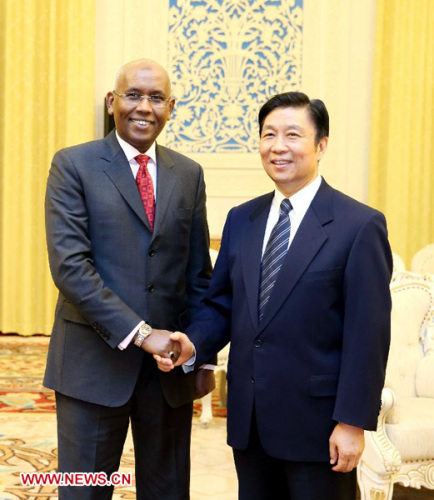 Li Yuanchao (R), a member of the Political Bureau of the Communist Party of China (CPC) Central Committee, meets with a delegation of the People's Rally for Progress of Djibouti headed by the party's general secretary Ilyas Moussa Dawaleh, also government