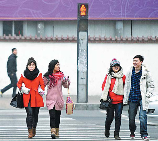 Pedestrians cross the road despite a visible red light in Taiyuan, Shanxi province. Fan Minda / Xinhua 