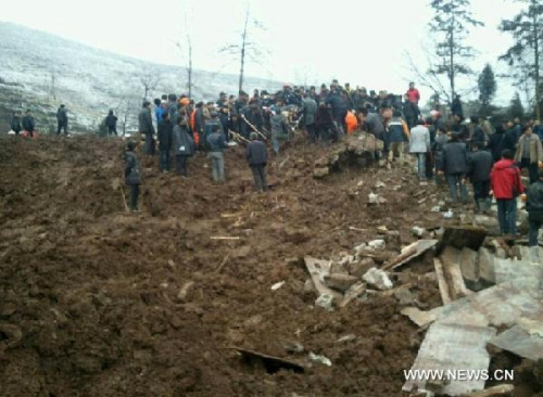 Rescuers work at the landslide site in this photo taken with a mobile phone at Gaopo Village of Zhenxiong County, southwest China's Yunnan Province, Jan. 11, 2013. More than 10 residential houses with over 40 people were buried after a landslide happened at the village early Friday morning, according to local officials. Eight people have been confirmed dead by now. (Xinhua/Wu Ruzhi) 