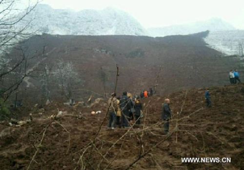 Photo taken on Jan. 11, 2013 shows the landslide site at the Gaopo Village of Zhenxiong County, southwest China's Yunnan Province. More than 10 local residential houses with over 40 people were buried after a landslide happened here early Friday morning, according to the local officials. Eight people have been confirmed dead by now. The rescue is still underway. (Xinhua/Wu Ruzhi) 
