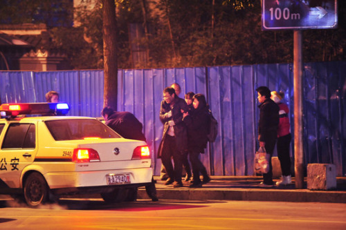 The reporter, dressed as a homeless man crouching at a crossroads while police come to give helps in Changsha city, central Chinas Hunan province, 7 January 2013. (Photo/Image China)
