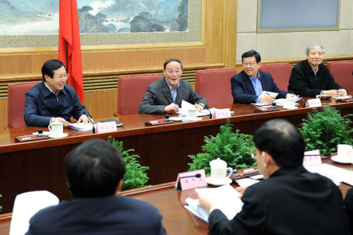 Chinese Vice Premier Wang Qishan (2nd L), who is also a member of the Standing Committee of the Political Bureau of the Communist Party of China (CPC) Central Committee, presides over a meeting on the crackdown on intellectual copyright infringement and counterfeit products in Beijing, capital of China, Jan. 18, 2013. (Xinhua/Li Tao)