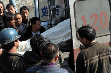 A victim of a coal mine accident is carried to an ambulance in Panxian county in the city of Liupanshui, southwest China's Guizhou Province, Jan. 21, 2013. The death toll of the accident which occurred on Friday afternoon at the Jinjia Coal Mine rose to five with eight others still trapped. Eighteen people were working underground when a gas explosion took place. (Xinhua/Yang Ying)