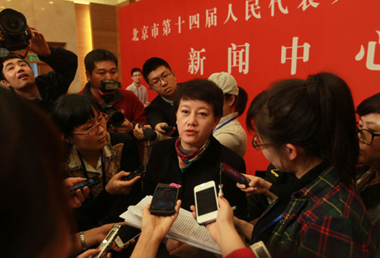 Li Xiaosong, deputy director of the Beijing Municipal Commission of Transport, takes questions from journalists at a news conference during the annual session of the city's legislature on Thursday in Beijing. Cui Meng / China Daily 
