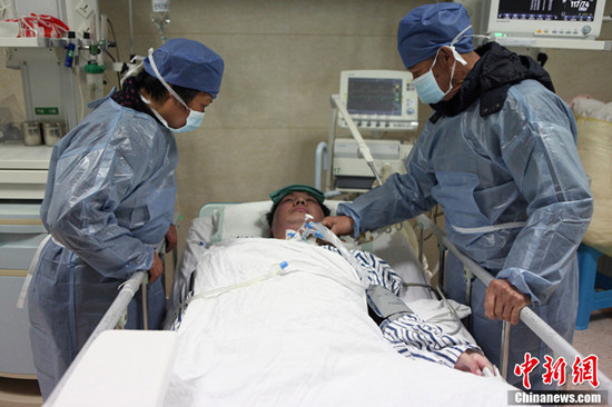 Fu Minzu and Wang Lanqin visit their son Fu Xuepeng in Taizhou No.1 People's Hospital in Zhejiang province on January 30, 2013. As the family's story recently became public knowledge, concerned people from all over the country began donating money and materials.