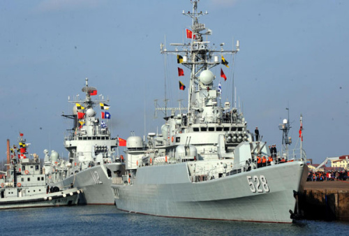 A missile frigate Mianyang (R) and a missile destroyer Harbin wait at a port in Qingdao city, East China's Shandong province, Feb 16, 2013, preparing to depart for the Gulf of Aden and the sea off Somalia on escort missions. The flotilla, as the 14th batch of its kind to engage in escort missions, consists of a missile destroyer and a frigate as well as a supply ship which are all from the North Sea Fleet of the People's Liberation Army (PLA) Navy. [Photo/Xinhua]