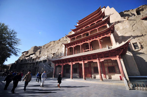 Tourists walk along a tower in the Mogao Grottoes in Dunhuang,Gansuprovince. [[Photo/Xinhua]