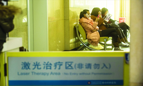 Young women sit in the waiting room at the Plastic Surgery Hospital, China Academy of Medical Science, in Shijingshan district on Thursday. Photo: Li Hao/GT 