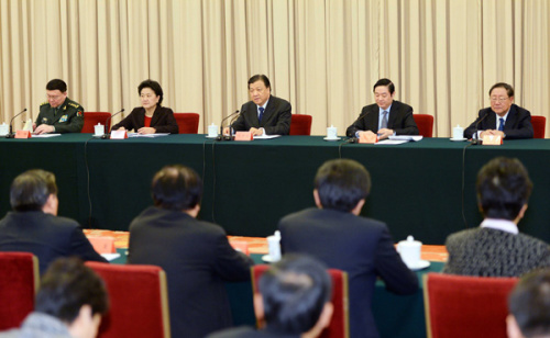 Liu Yunshan (C back), a member of the Standing Committee of the Political Bureau of the Communist Party of China (CPC) Central Committee and head of the Spiritual Civilization Steering Committee of the 18th CPC Central Committee, attends a symposium commemorating the 50th anniversary of inscription for Lei Feng by Mao Zedong and other veteran revolutionaries in Beijing, capital of China, March 1, 2013. Lei Feng is China's iconic soldier who embodied selflessness and died during an accident at the age of 22 in 1962. The late Chairman Mao Zedong once encouraged the whole nation to learn from Lei's passion for helping others and his devotion to work. (Xinhua/Li Tao)