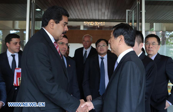 Venezuela's Acting President Nicolas Maduro (L front) meets with Zhang Ping (R front), head of the National Development and Reform Commission and special envoy of Chinese President Hu Jintao, in Caracas, March 9, 2013. China is willing to continue to stre