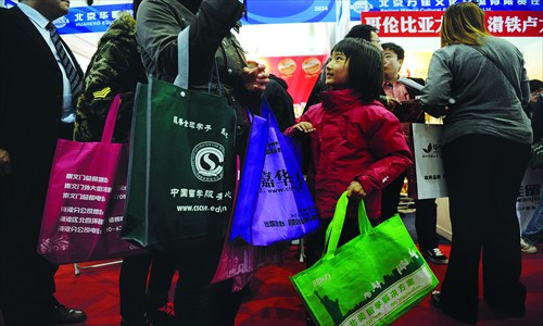 A young girl is accompanied by her mother at the 2013 China International Education Exhibition Tour in Chaoyang district Monday Photo: Li Hao/GT 