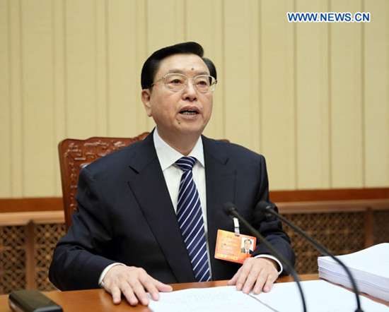 Zhang Dejiang, executive chairperson of the presidium of the first session of the 12th National People's Congress (NPC), presides over the third meeting of the presidium at the Great Hall of the People in Beijing, capital of China, March 12, 2013. (Xinhua/Lan Hongguang)