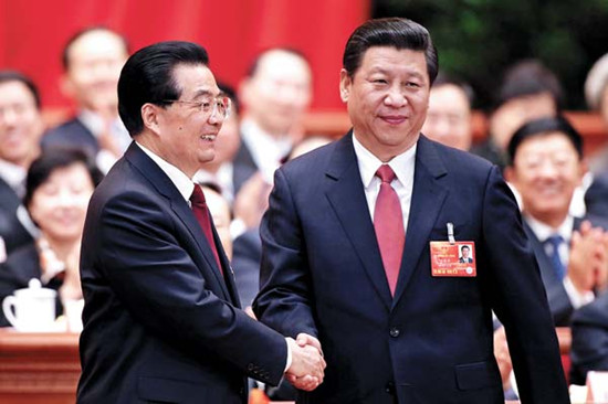President Xi Jinping is congratulated by his predecessor Hu Jintao after his election at the fourth plenary meeting of the first session of the 12th National People's Congress on Thursday in Beijing. [Wu Zhiyi / China Daily]