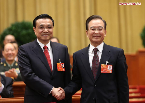 Wen Jiabao (R) shakes hands with Li Keqiang at the fifth plenary meeting of the first session of the 12th National People's Congress (NPC) at the Great Hall of the People in Beijing, capital of China, March 15, 2013. Li Keqiang was endorsed as the premier