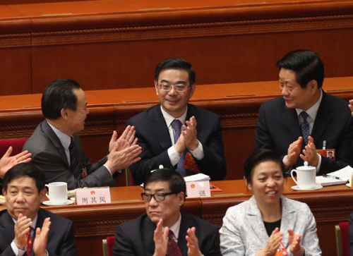 Zhou Qiang (C back) is congratulated by other deputies after being elected president of the Supreme People's Court of China at the fifth plenary meeting of the first session of the 12th National People's Congress (NPC) in Beijing, capital of China, March 