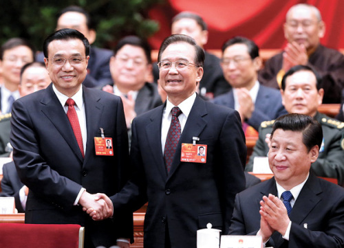 Premier Li Keqiang is congratulated by his predecessor Wen Jiabao after his election, while President Xi Jinping applauds at the fifth plenary meeting of the first session of the 12th National Peoples Congress on Friday in Beijing. [Wu Zhiyi / China Daily]