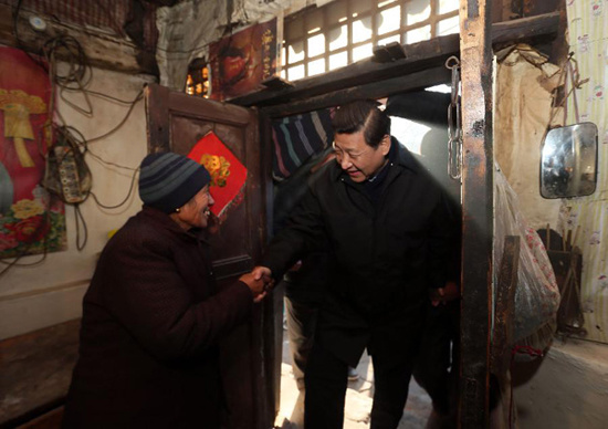 In this file photo taken on Dec. 30, 2012, Xi Jinping (R) visits an impoverished villager in the Luotuowan Village of Fuping County, north China's Hebei Province. (Xinhua/Lan Hongguang)