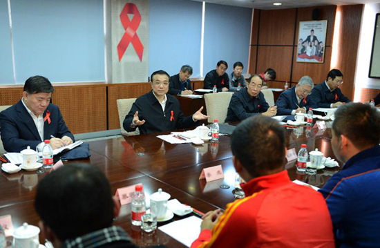 In this file photo taken on Nov. 26, 2012, Li Keqiang (2nd L, back) speaks at a symposium attended by representatives of HIV/AIDS related domestic non-government organizations and international organizations in Beijing, capital of China. (Xinhua/Ma Zhancheng)
