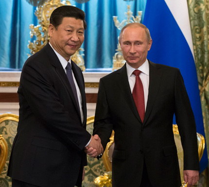 President Xi Jinping and his Russian counterpart Vladimir Putin shake hands during their meeting at the Ornate St George Hall in the gilded Kremlin in Moscow yesterday. Xi urged Russia to work closer with China on foreign policy matters in order to better protect their joint security and interests. Putin said Russian-Chinese relations are a very important factor in world politics.