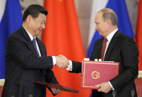 President Xi Jinping shakes hands with Russian President Vladimir Putin during a document signing ceremony in Moscow. [Photo/Agencies]