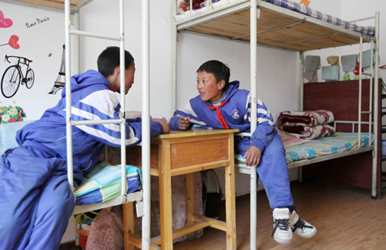 Two Tibetan students chat in a dorm at the China-Congo Friendship Primary School on March 15. Photos by Wang Jing / China Daily