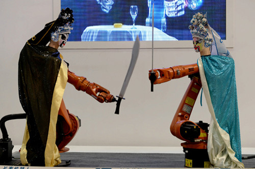 Robots clad in Peking Opera costumes display their technical ability at an exhibition in Chongqing on Thursday. ZHOU HUI / FOR CHINA DAILY