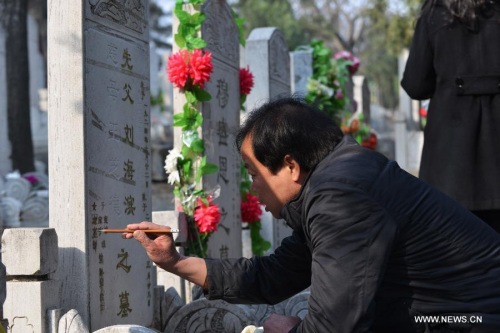 A man refurbishes his family members' tombstone at the Babaoshan People's Cemetery in Beijing, capital of China, March 30, 2013. Citizens have begun to remember and honour their deceased family members and ancestors as the annual Qingming Festival draws near. The Qingming Festival, also known as Tomb Sweeping Day, is usually observed by the Chinese around April 5 each year. (Xinhua/Wang Quanchao) 