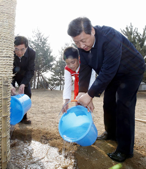 President Xi Jinping waters a newly planted tree in Fengtai district, Beijing, on Tuesday, in a move to improve public awareness of environmental protection. Photo by Ju Peng / Xinhua