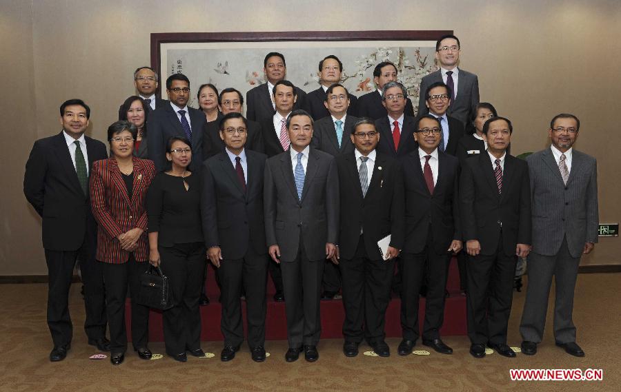 Chinese Foreign Minister Wang Yi (front, 5th L) poses for a group photo with senior officials of the Association of Southeast Asian Nations (ASEAN) and diplomats of ASEAN countries to China, ahead of their meeting in Beijing, capital of China, April 2, 2013. The 19th China-ASEAN Senior Officials' Consultation was held in Beijing on Tuesday. (Xinhua/Rao Aimin)