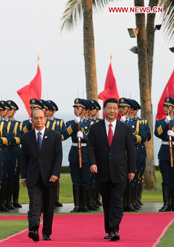 Chinese President Xi Jinping (R front) accompanies Myanmar's President U Thein Sein (L front) to inspect the guard of honor during a welcoming ceremony held by President Xi Jinping for President U Thein Sein in Sanya, south China's Hainan Province, April 