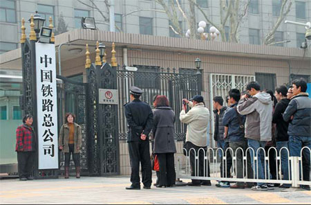 People line up to pose for photographs at the entrance of China Railway Corporation, a company established to take over the commercial duties of the now defunct Ministry of Railways. Provided to China Daily