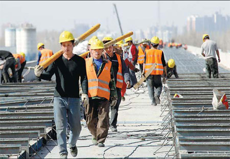 Workers build a new high-speed railway link between Lanzhou in Gansu province and Urumqi in the Xinjiang Uygur autonomous region. The 1,776-km route is due to start operation in 2014. Cai Zengle / for China Daily