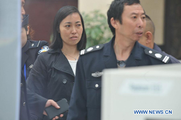 Tang Hui, mother of a young rape victim who is suing a local authority for putting her into a labor camp, receives security check before a court hearing begins at the Yongzhou Intermediate People's Court in Yongzhou City, central China's Hunan Province, A