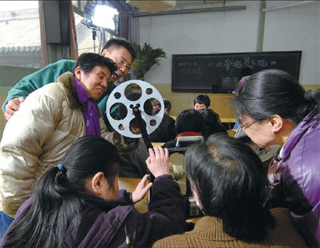 Visually impaired people learning about film projectors at the Beijing Hongdandan Educational and Cultural Exchange Center in 2007. Provided to China Daily